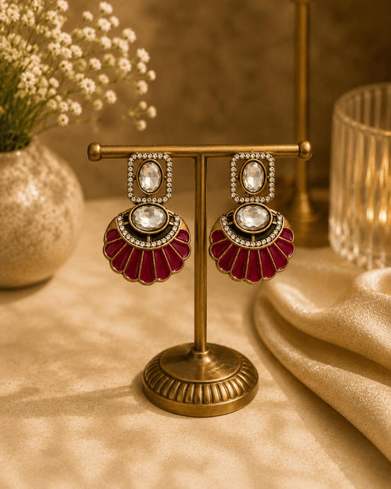 Gold-tone drop earrings with maroon enamel fan dangles and oval crystal centers