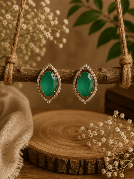 Green teardrop halo stud earrings on display stand, pavé crystal bezel, gold-tone.