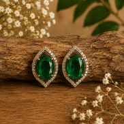 Green teardrop halo stud earrings with pave crystal border, gold-tone setting.