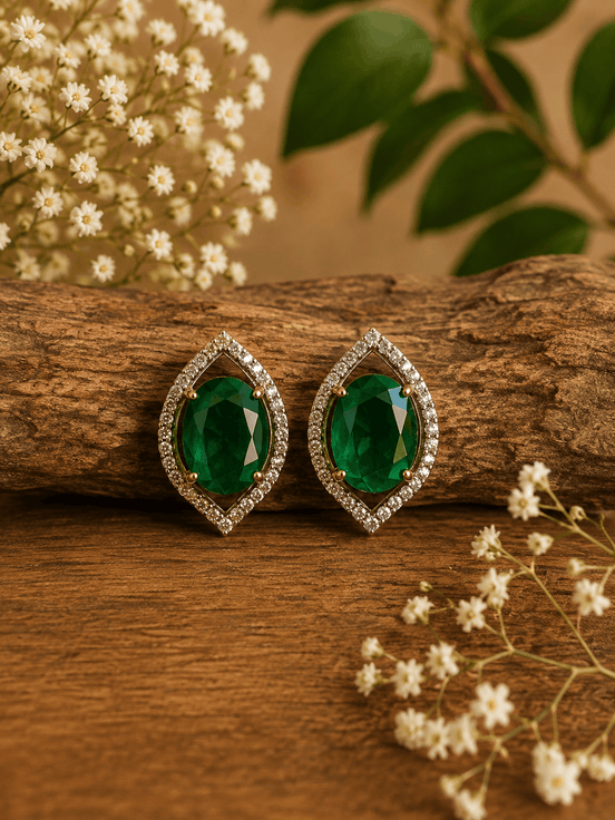 Green teardrop halo stud earrings with pave crystal border, gold-tone setting.