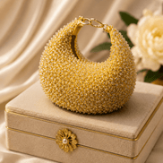 Gold crystal beaded hobo bag with flower-shaped clasp and chain strap