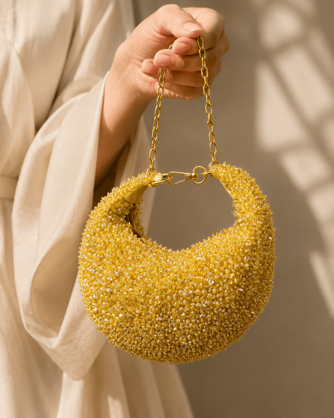 Gold crystal beaded hobo bag held by chain, teardrop shoulder style