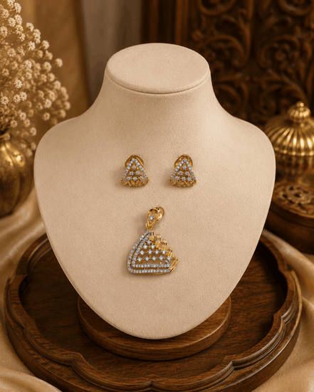 Gold-tone pendant and matching stud earrings displayed on jewelry bust