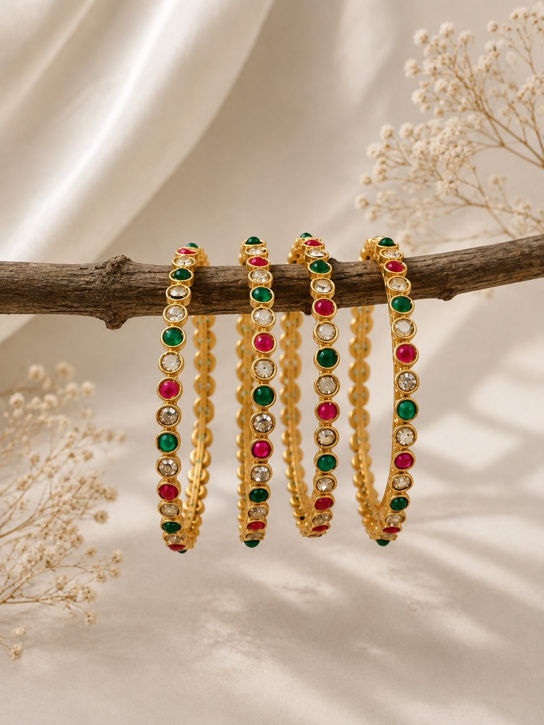 Nayra Royal gold-tone bangles with green and pink bead rows and red center stones