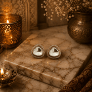 Gold-tone crystal stud earrings, round faceted clear stone in jeweled halo setting.