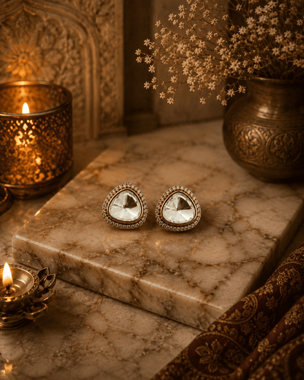 Gold-tone crystal stud earrings, round faceted clear stone in jeweled halo setting.