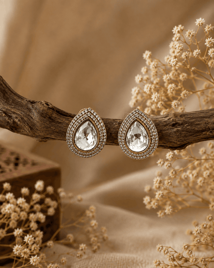 Gold-tone teardrop stud earrings with clear center crystal and sparkling halo border