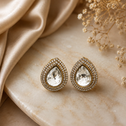 Teardrop stud earrings with gold-tone frame, clear center crystal, double halo