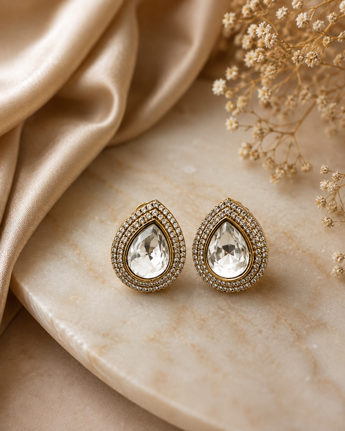 Teardrop stud earrings with gold-tone frame, clear center crystal, double halo