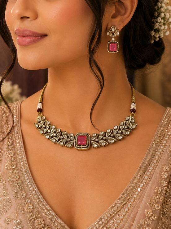 Ruby-pink square-stone choker necklace with ornate gold detailing and stud drop earrings.