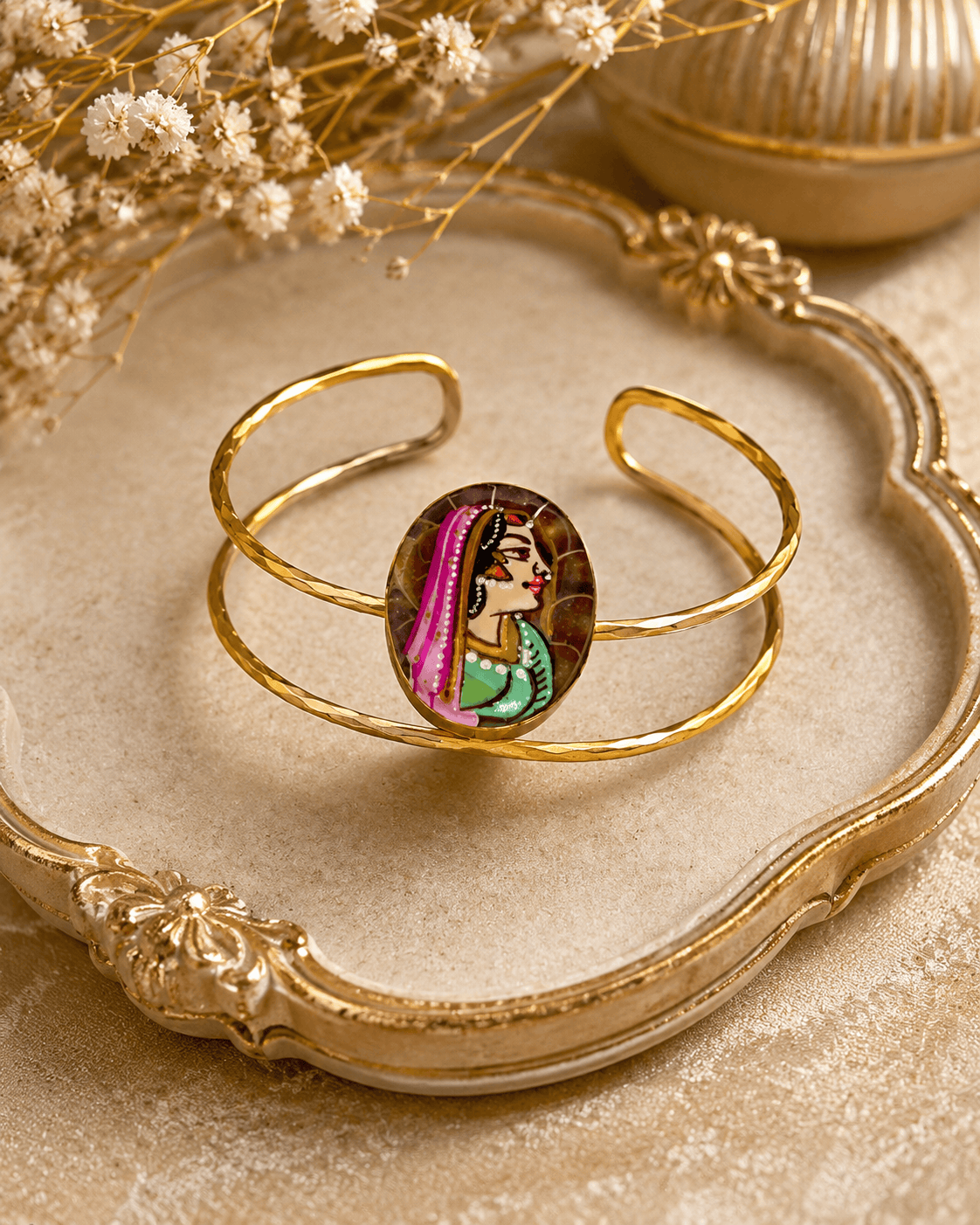 Gold-tone oval enamel face cuff bracelet on decorative base