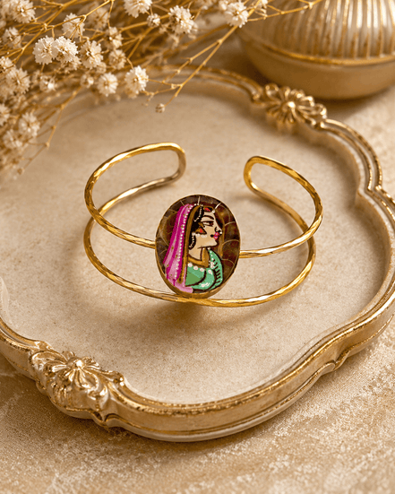 Gold-tone oval enamel face cuff bracelet on decorative base