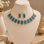 Teal blue gemstone choker with matching drop earrings on necklace bust