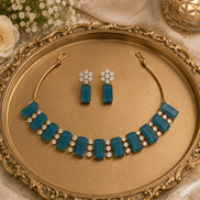 Teal blue gemstone choker and matching drop earrings with gold-tone settings
