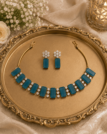 Teal blue gemstone choker and matching drop earrings with gold-tone settings