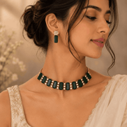 Emerald green gemstone choker with matching drop earrings and gold-tone details
