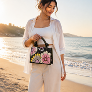 Black floral beaded handbag with pink and yellow flower sequins and braided handles