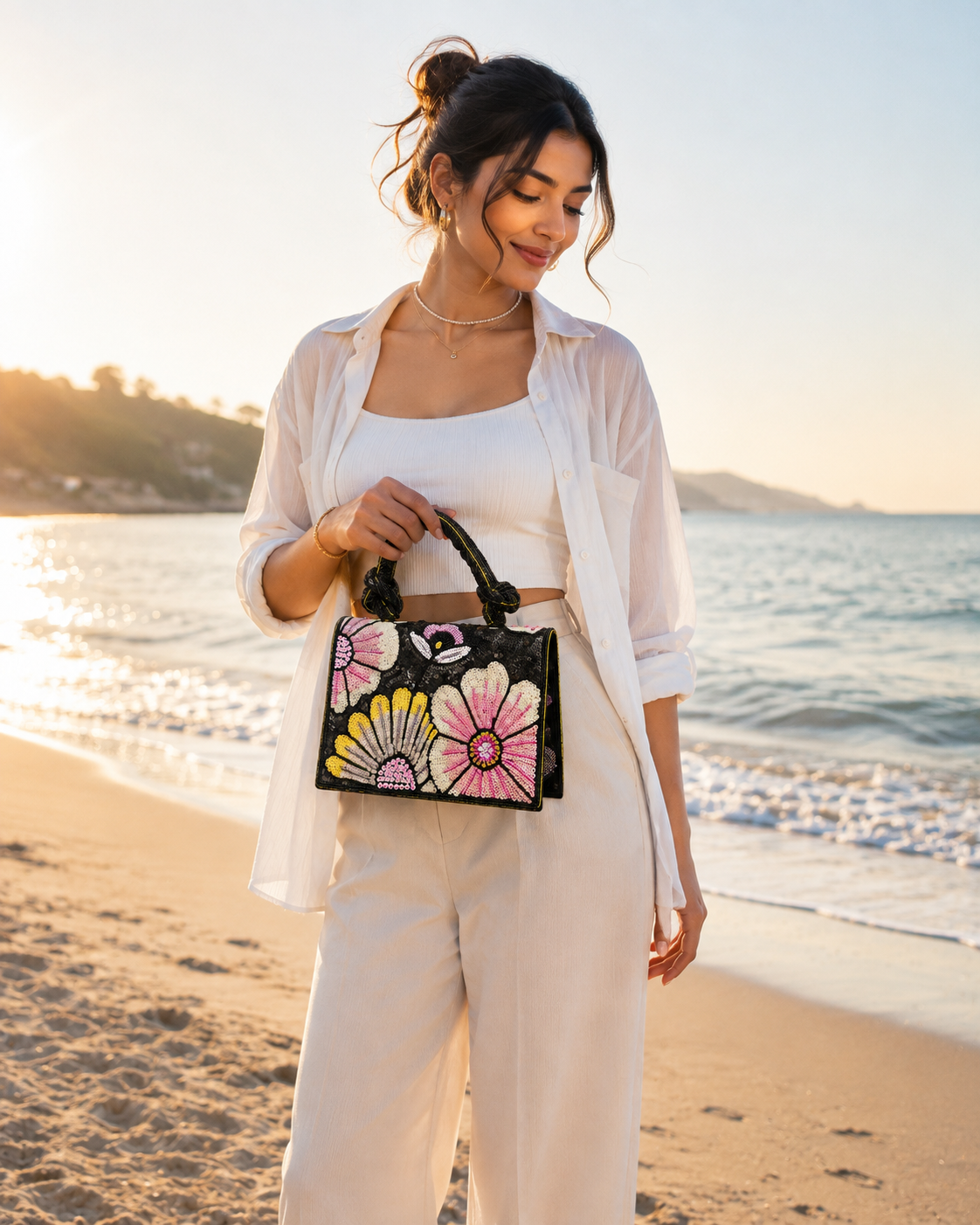 Black floral beaded handbag with pink and yellow flower sequins and braided handles