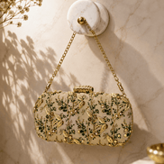 Embroidered beaded clutch bag with green floral details and gold chain strap.