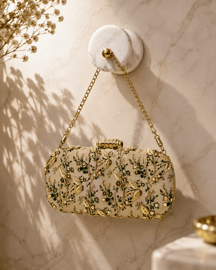 Embroidered beaded clutch bag with green floral details and gold chain strap.