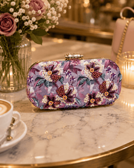 Floral sequin clutch bag in purple and pink with decorative bow-like beads.