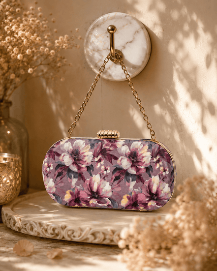 Floral sequin clutch bag with pink and purple flowers, gold chain shoulder strap.