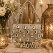 Beige embellished shoulder bag with dangling teardrop bead fringe and chain handles