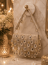Beige beaded shoulder bag with teardrop drops and chain shoulder straps, front view