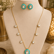 Gold-tone necklace with turquoise center pendant and matching stud earrings