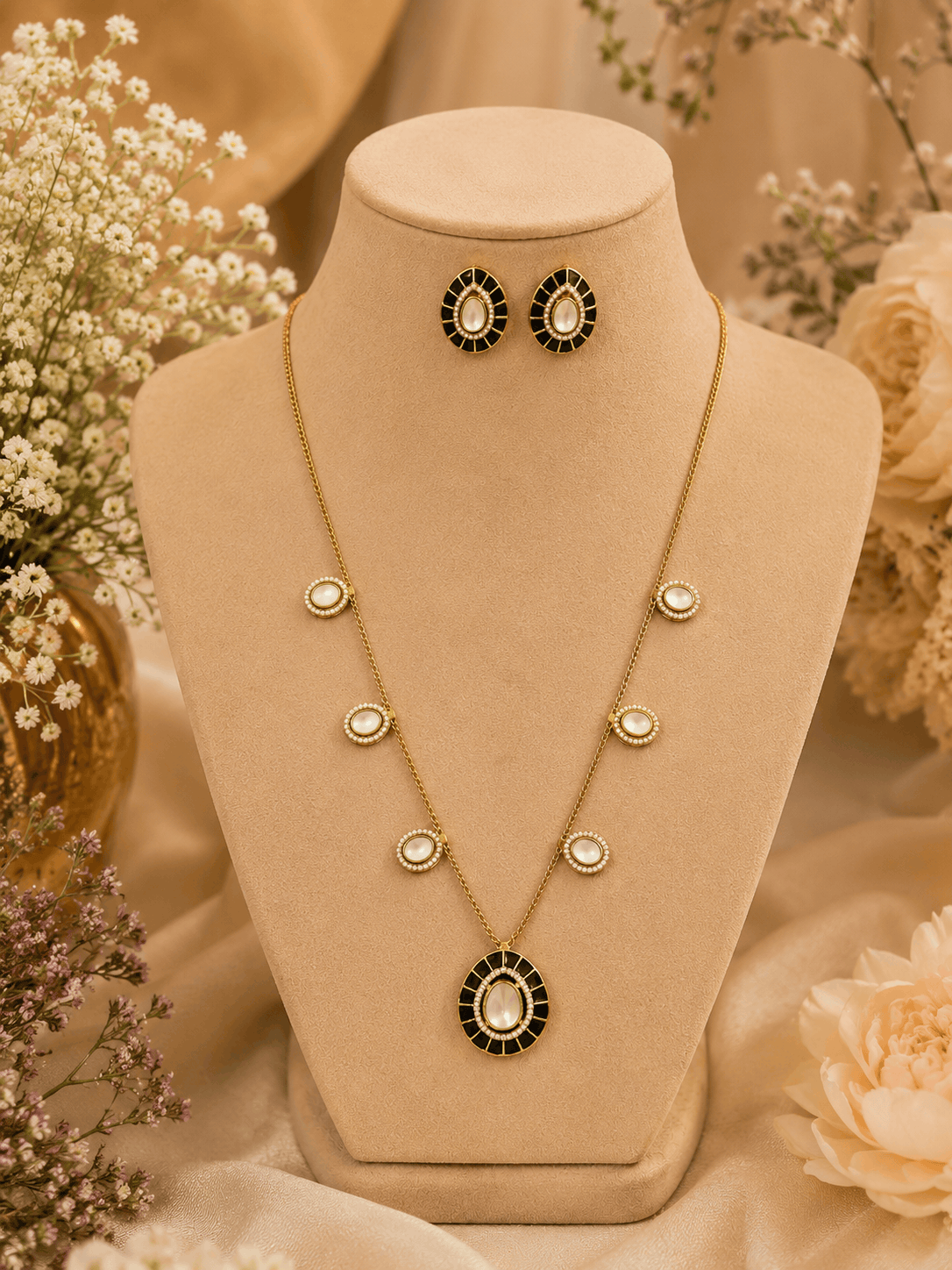 Gold-tone necklace set with black oval center pendant and matching stud earrings