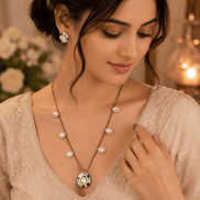 Gold-tone necklace with turquoise center pendant and matching stud earrings on model
