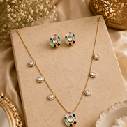 Gold-tone necklace set with turquoise and multicolor center pendant and stud earrings