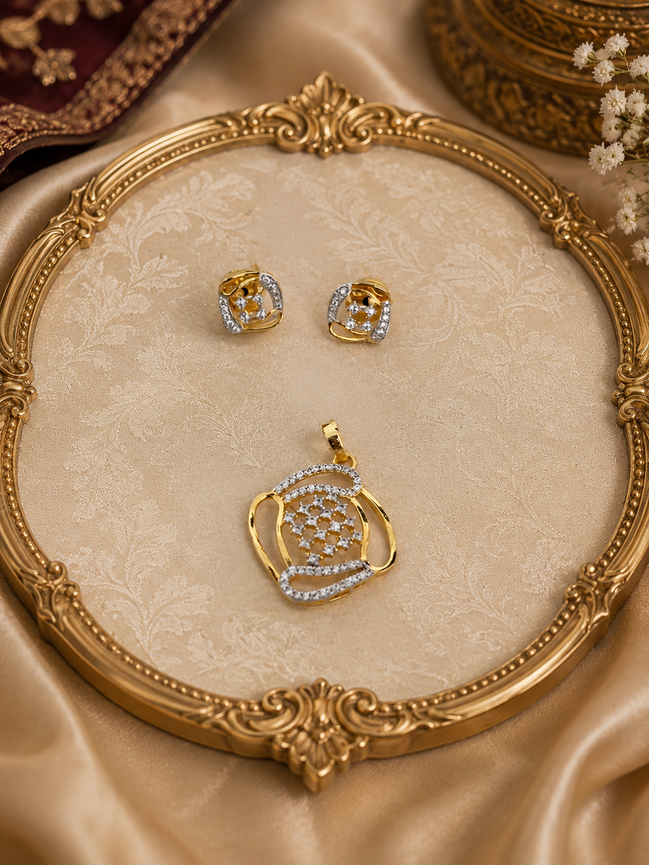 Gold-tone pendant and blue crystal stud earrings on ornate round tray