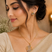 Gold-tone teardrop pendant necklace with blue crystal stud earrings on model