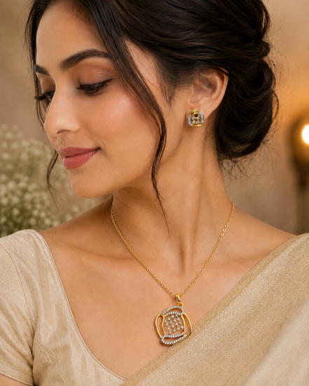Gold-tone teardrop pendant necklace with blue crystal stud earrings on model