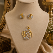 Gold-tone pendant necklace with blue crystal stud earrings on display bust