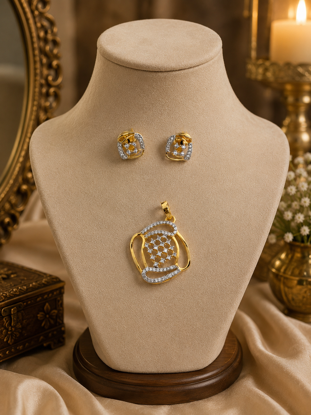 Gold-tone pendant necklace with blue crystal stud earrings on display bust