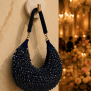 Navy blue beaded hobo bag with loop handle and chain tassels