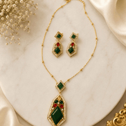 Gold-tone gemstone pendant necklace set with green and red drop earrings