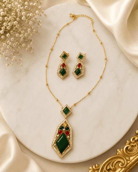 Gold-tone gemstone pendant necklace set with green and red drop earrings