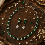 Emerald-green beaded necklace and drop earrings with glossy stones and silver settings