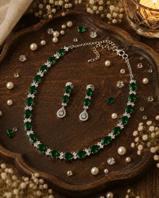 Emerald-green beaded necklace and drop earrings with glossy stones and silver settings
