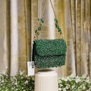 Emerald green crystal mini bag front view with long chain straps and scalloped flap