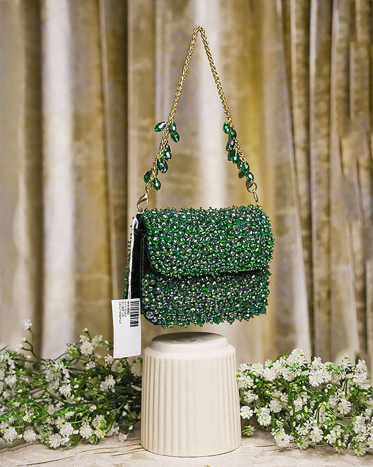 Emerald green crystal mini bag front view with long chain straps and scalloped flap