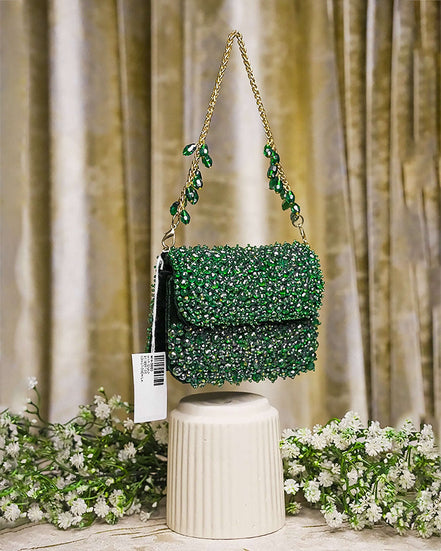 Emerald green crystal mini bag front view with long chain straps and scalloped flap