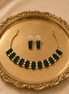 Emerald green gemstone choker and matching drop earrings with gold-tone settings