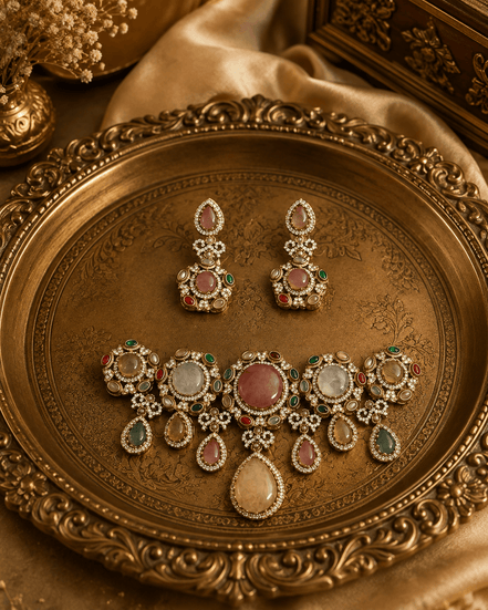 Gold-toned jewelry set with pink and green stones: necklace and matching earrings