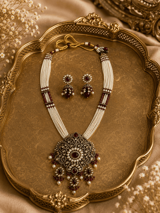 Heritage necklace set with layered bead strands, ornate pendant and matching drop earrings.