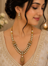 Gold kundan necklace set with peacock-blue teardrop pendant and matching drop earrings