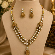 Gold kundan necklace set with peacock-blue oval pendant, layered pearl chain, and studs